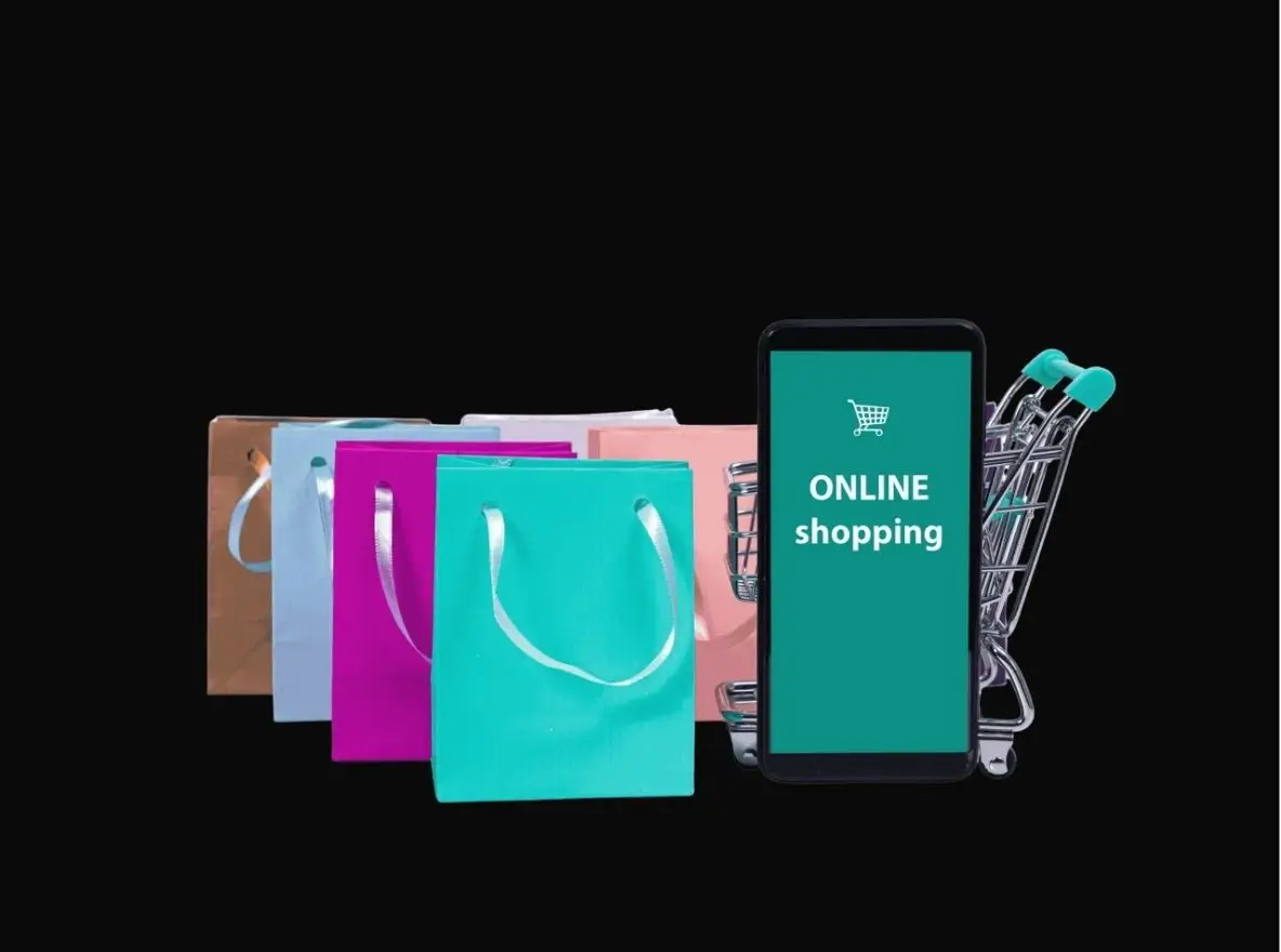 Smartphone mit Anzeige „Online Shopping“, bunte Papiertüten und Einkaufswagen, Symbol für E-Commerce Lernen und digitalen Einzelhandel